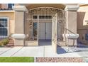 Elegant entryway with ornate iron gate and double doors at 1559 Via Della Scala, Henderson, NV 89052