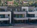 Modern home exterior with multiple levels and balconies at 20 Lakefront Dr, Henderson, NV 89011