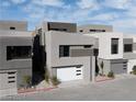 Modern home exterior with a white garage door at 20 Lakefront Dr, Henderson, NV 89011