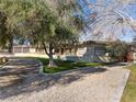 Ranch style home with a curved driveway and landscaping at 2800 Ashby Ave, Las Vegas, NV 89102