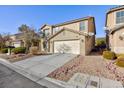 Two-story house with beige exterior, attached garage, and landscaping at 312 Bella Calabria Ave, Las Vegas, NV 89183