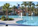 Community pool with inviting, clear waters, surrounded by palm trees, and stone accents at 334 Sea Rim Ave, Las Vegas, NV 89148