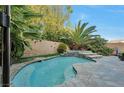 Enjoy this refreshing kidney-shaped pool in the backyard at 334 Sea Rim Ave, Las Vegas, NV 89148