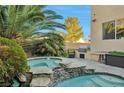 Inviting spa and pool area with a stone deck and built-in grill at 334 Sea Rim Ave, Las Vegas, NV 89148