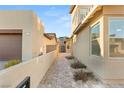 Brick walkway between two houses leading to a gated entryway at 425 Crown Mesa Ave, Las Vegas, NV 89138