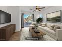 Bright Gathering room with hardwood floors and sliding doors to the backyard at 5536 Valensole Ave, Las Vegas, NV 89141