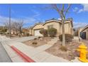 House exterior showcasing a garage and neat landscaping at 6054 Sierra Medina Ave, Las Vegas, NV 89139