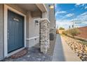 Front entrance with stone pillars and dark gray door at 6521 Taffrail Ave, Las Vegas, NV 89118