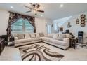 Spacious living room with L-shaped sectional sofa and large TV at 6521 Taffrail Ave, Las Vegas, NV 89118