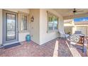 Inviting front porch with seating area and brick flooring at 759 Shadow Reef St, Henderson, NV 89011