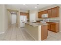 Bright kitchen featuring tile floors, granite countertops, and stainless steel appliances at 7659 Dewy Falls Ave, Las Vegas, NV 89179