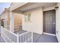 Inviting front porch with a gray door and white railing at 9009 Careful Canvas Ave, Las Vegas, NV 89149