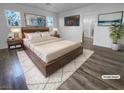 Spacious primary bedroom with wood-look floors and large windows at 9133 Black Beauty St, Las Vegas, NV 89113