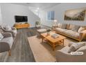 Virtually staged living room with light flooring and neutral furniture at 9133 Black Beauty St, Las Vegas, NV 89113