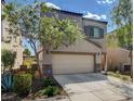 Two-story house with tan siding, stone accents, and a two-car garage at 9417 Sand Tiger Ave, Las Vegas, NV 89148