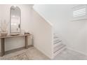 Bright entryway with staircase, mirror, and console table at 10009 Cabernet Hills St, Las Vegas, NV 89141