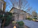 Two-story house with stone accents and a two-car garage at 10273 Aragon Crown Rd, Las Vegas, NV 89135