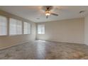 Expansive living room featuring tile flooring, ample natural light, and a modern ceiling fan at 10273 Aragon Crown Rd, Las Vegas, NV 89135