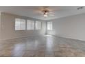 Bright and airy living room with tile flooring, recessed lighting, and multiple windows at 10273 Aragon Crown Rd, Las Vegas, NV 89135