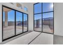 Bright living room featuring large windows, offering abundant natural light and an outside view at 10739 Agate Cliffs Ave, Las Vegas, NV 89135