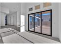 Living room with a sliding glass door that leads to the outside patio area at 10739 Agate Cliffs Ave, Las Vegas, NV 89135