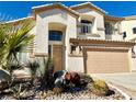 Stunning two-story house featuring a light beige exterior and landscaping at 109 Lakewood Garden Dr, Las Vegas, NV 89148