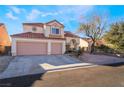 Two-story house with three-car garage and desert landscaping at 1105 Thornfield Ln, Las Vegas, NV 89123