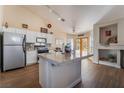 Spacious kitchen with island, stainless steel appliances, and wood flooring at 1105 Thornfield Ln, Las Vegas, NV 89123