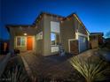 Single story home with red door, brick accents, and well-manicured landscaping at 1297 Paseo Del Oso Ln, Henderson, NV 89002