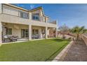 Spacious backyard with artificial turf and covered patio at 1738 Sonoran Bluff Ave, Henderson, NV 89014