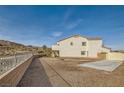 Expansive backyard with gravel ground cover, concrete pad, and partial fencing offering a versatile outdoor space at 1738 Sonoran Bluff Ave, Henderson, NV 89014