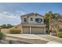 Charming two-story home features a three-car garage, paved driveway, and manicured landscaping for great curb appeal at 1738 Sonoran Bluff Ave, Henderson, NV 89014