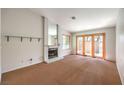 Bright living room with fireplace and sliding glass doors to patio at 2360 Pickwick Dr, Henderson, NV 89014