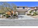 Two-story house with a landscaped yard and attached garage at 2892 Rothesay Ave, Henderson, NV 89044