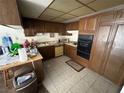 Galley style kitchen with wood cabinets and built in oven at 3345 Medina Ct, Las Vegas, NV 89121