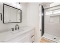 Modern bathroom with white vanity, quartz countertop, and a walk-in shower at 3875 Sebasco Dr, Las Vegas, NV 89147