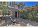 Inviting courtyard with stone accents, cozy seating, and lush greenery offers an intimate outdoor retreat at 4450 Palisades Canyon Cir, Las Vegas, NV 89129