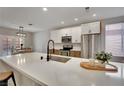 Bright kitchen with quartz countertops, stainless steel appliances, and seating at the island at 511 Dalgreen Pl, Henderson, NV 89012