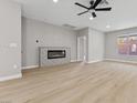 Living area with hardwood floors and a modern linear fireplace at 511 Dalgreen Pl, Henderson, NV 89012