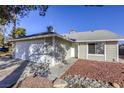 House exterior showcasing a two-car garage and stone landscaping at 6008 Carmel Way, Las Vegas, NV 89108