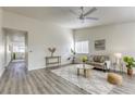 Bright living room with hardwood floors, comfy seating and a ceiling fan at 6008 Carmel Way, Las Vegas, NV 89108