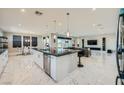 Open-concept living space features marble floors and a modern kitchen and living area at 6834 Compass St, North Las Vegas, NV 89084