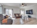 Spacious living room with hardwood floors, a large TV, and comfortable seating at 8627 Roping Rodeo Ave # 103, Las Vegas, NV 89178