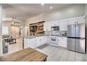 Modern kitchen with white cabinets, stainless steel appliances, and a large island at 8836 Big Bear Pines Ave, Las Vegas, NV 89143