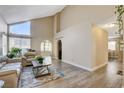 Spacious living room with vaulted ceilings and light wood flooring at 9636 Swan Bay Dr, Las Vegas, NV 89117