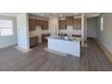 Open-concept kitchen featuring an island, modern grey cabinets, and stainless steel sink at 10039 Sir Atlas Ct, Las Vegas, NV 89148