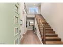 Modern staircase with wood steps and metal railing at 10286 Jade Gardens Dr, Las Vegas, NV 89135