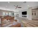 Spacious living room with leather sectional sofa and fireplace at 10509 India Hawthorn Ave, Las Vegas, NV 89144