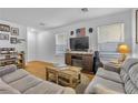 Bright living room with hardwood floors, comfy sofas, and a fireplace at 1129 Majestic Canyon St, Henderson, NV 89052