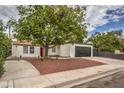 Single story home with red front door and newly landscaped yard at 145 Hancock St, Las Vegas, NV 89110